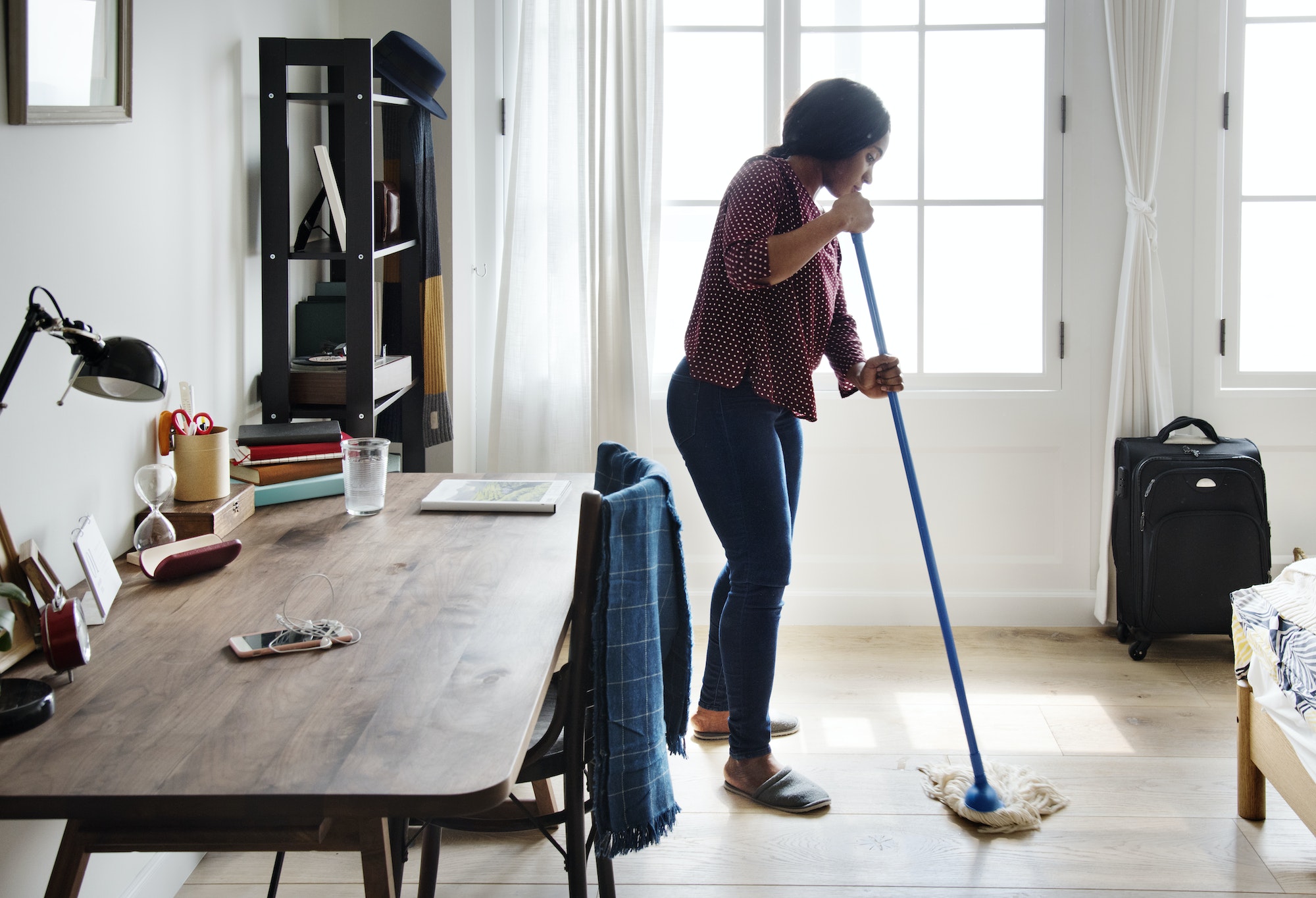 Black woman cleaning room